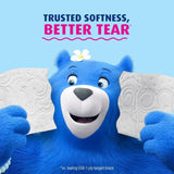 Blue bear character holding tissues with text 'Trusted Softness, Better Tear' on a blue background
