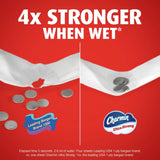 Advertisement showing Charmin Ultra Strong toilet paper with coins on a red background