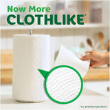 Kitchen setting with paper towel roll and hand pulling a sheet, emphasizing 'clothlike' texture.