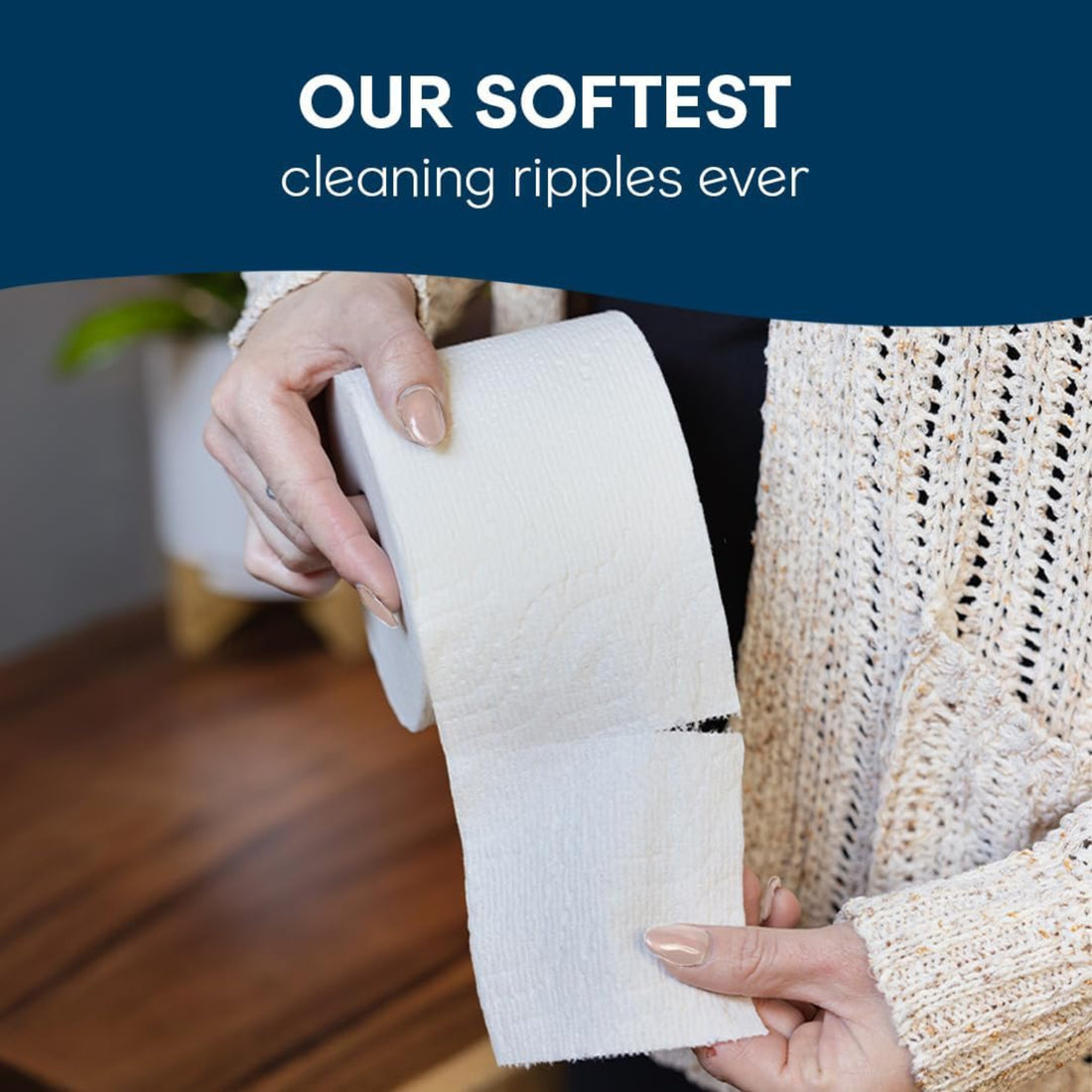 Person holding a roll of white fabric with text 'Our Softest cleaning ripples ever' on a blue background