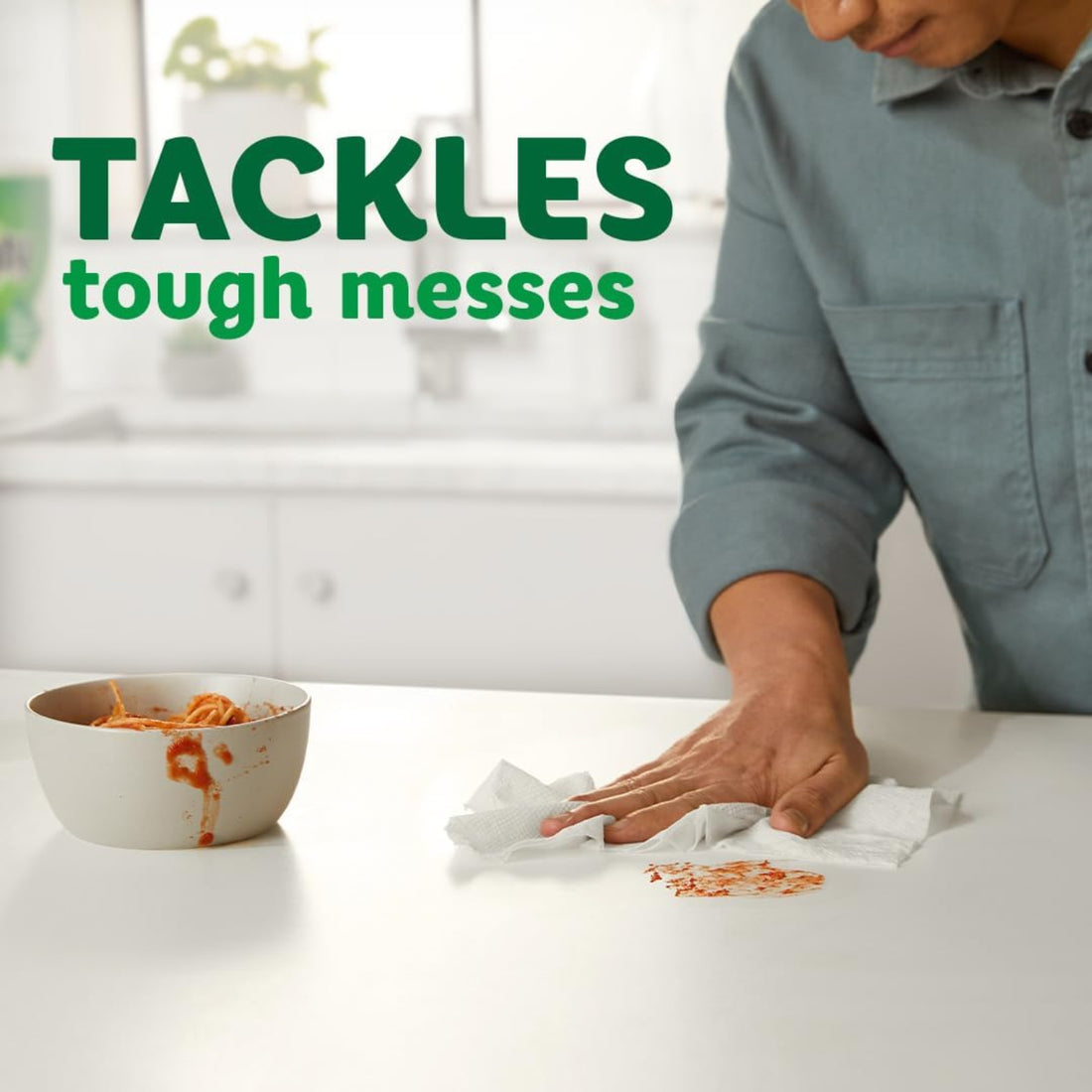 Person cleaning up a mess with text 'TACKLES tough messes' in a kitchen setting.