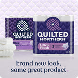 Two packages of Quilted Northern Ultra Plush toilet paper on a white surface with a purple patterned background.
