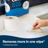 Person cleaning a surface with a wipe, with Colgate Ultra Clean product in the background.