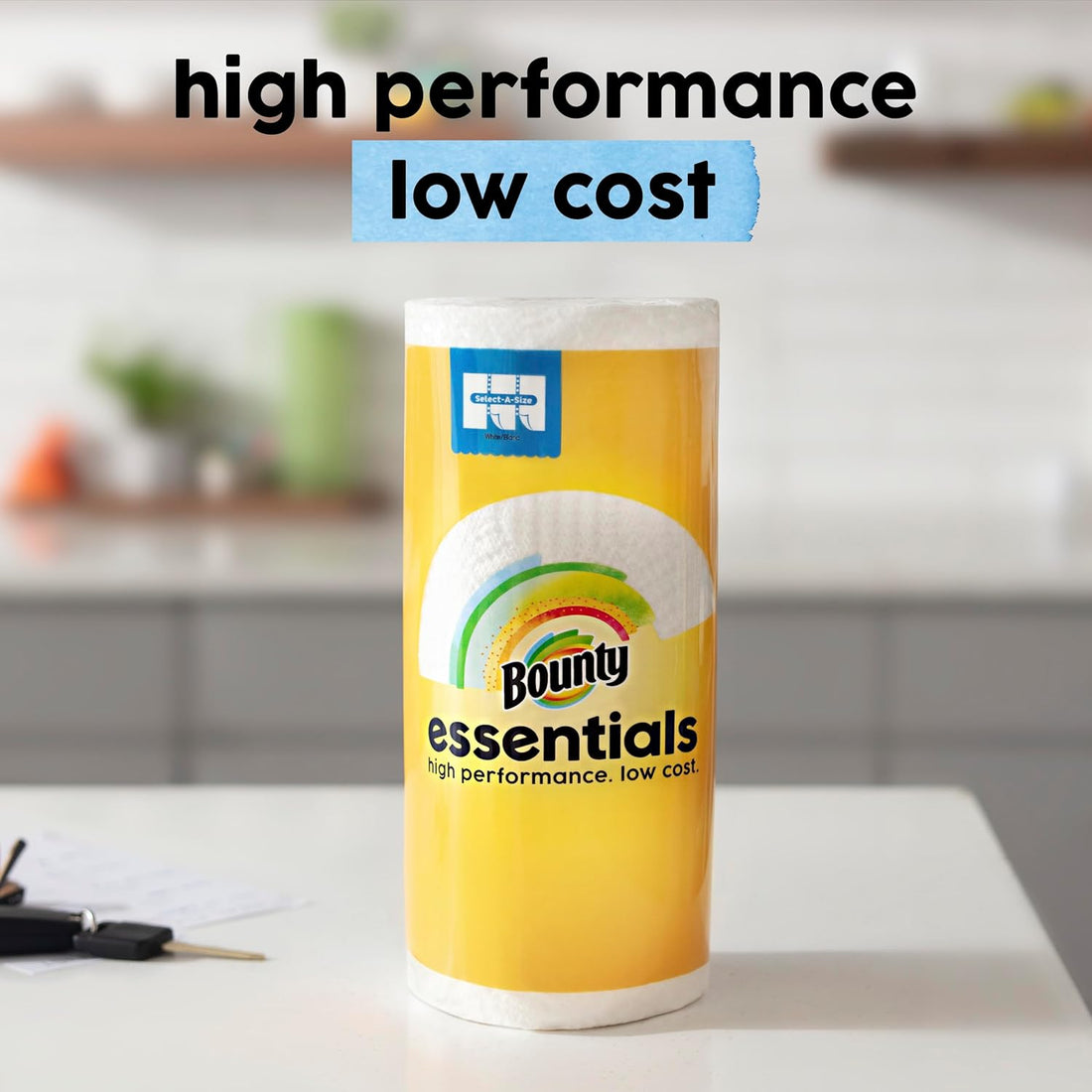 Bounty essentials paper towels on a kitchen counter with text 'high performance low cost'.
