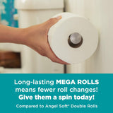 Hand holding a Mega Roll of toilet paper with promotional text on a teal banner.
