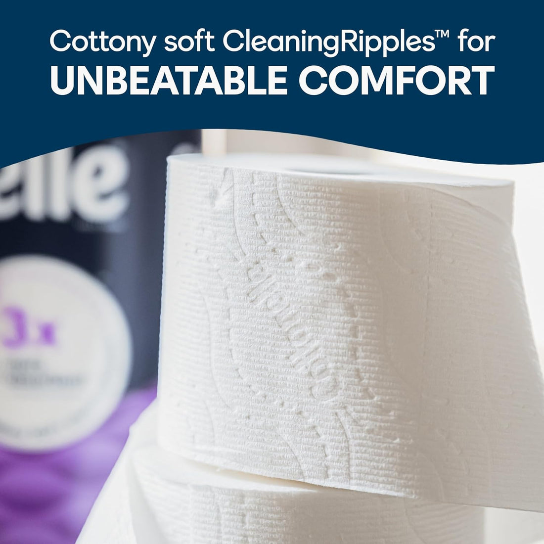 Roll of white toilet paper with text about 'Cottony soft CleaningRipples' and 'UNBEATABLE COMFORT'.