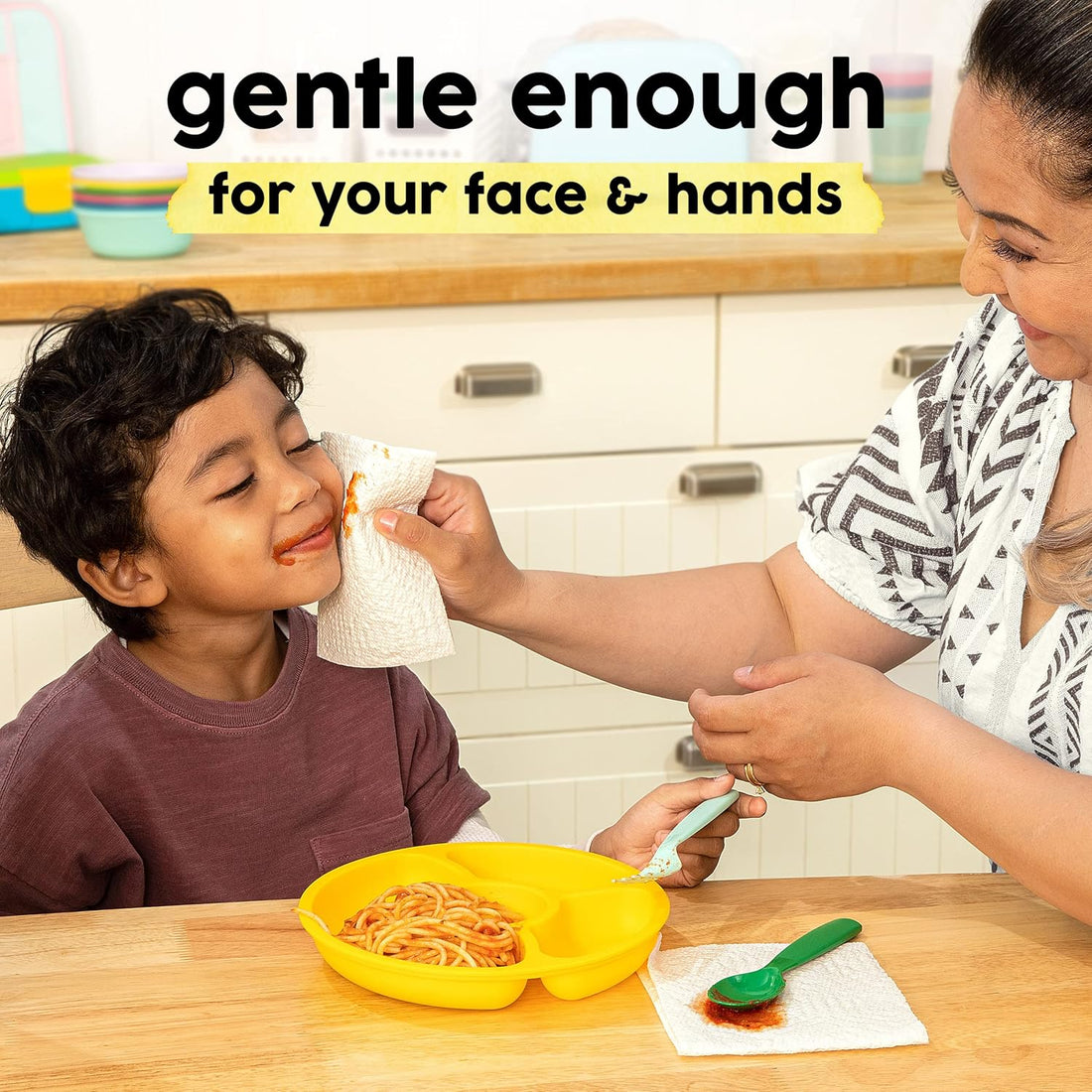Woman helping a child with spaghetti at a kitchen table, with text 'gentle enough for your face & hands' above.